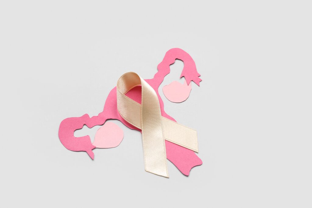 paper,uterus,with,beige,ribbon,on,light,background.,cancer,awareness