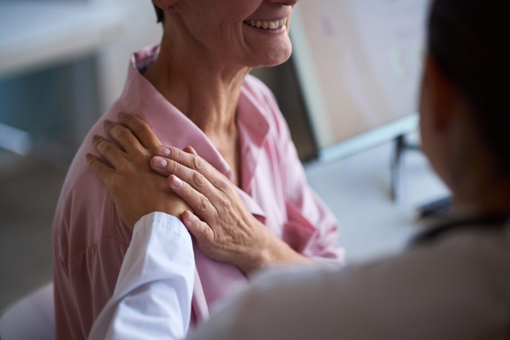 middle,aged,caucasian,woman,sitting,in,medical,office,receiving,comforting