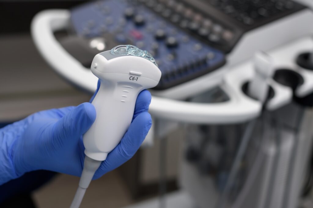 close up,of,ultrasound,diagnostic,probe.,a,doctor's,hands,hold,a