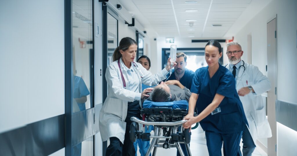 diverse,emergency,medical,team,rushing,down,a,hospital,corridor,,carefully
