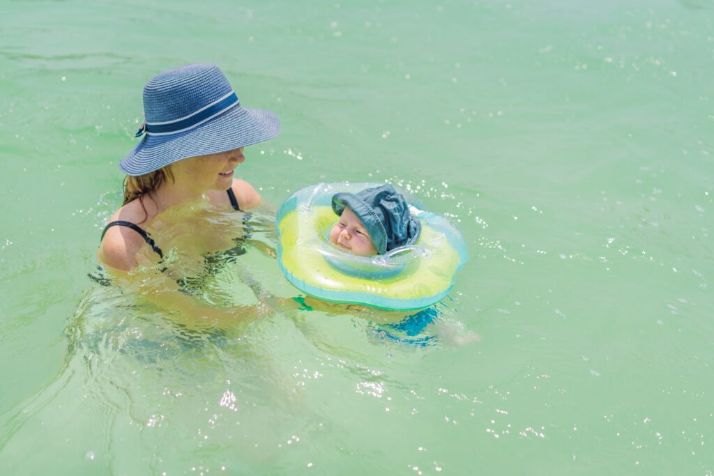 baby,floating,in,a,neck,ring,in,turquoise,water,with