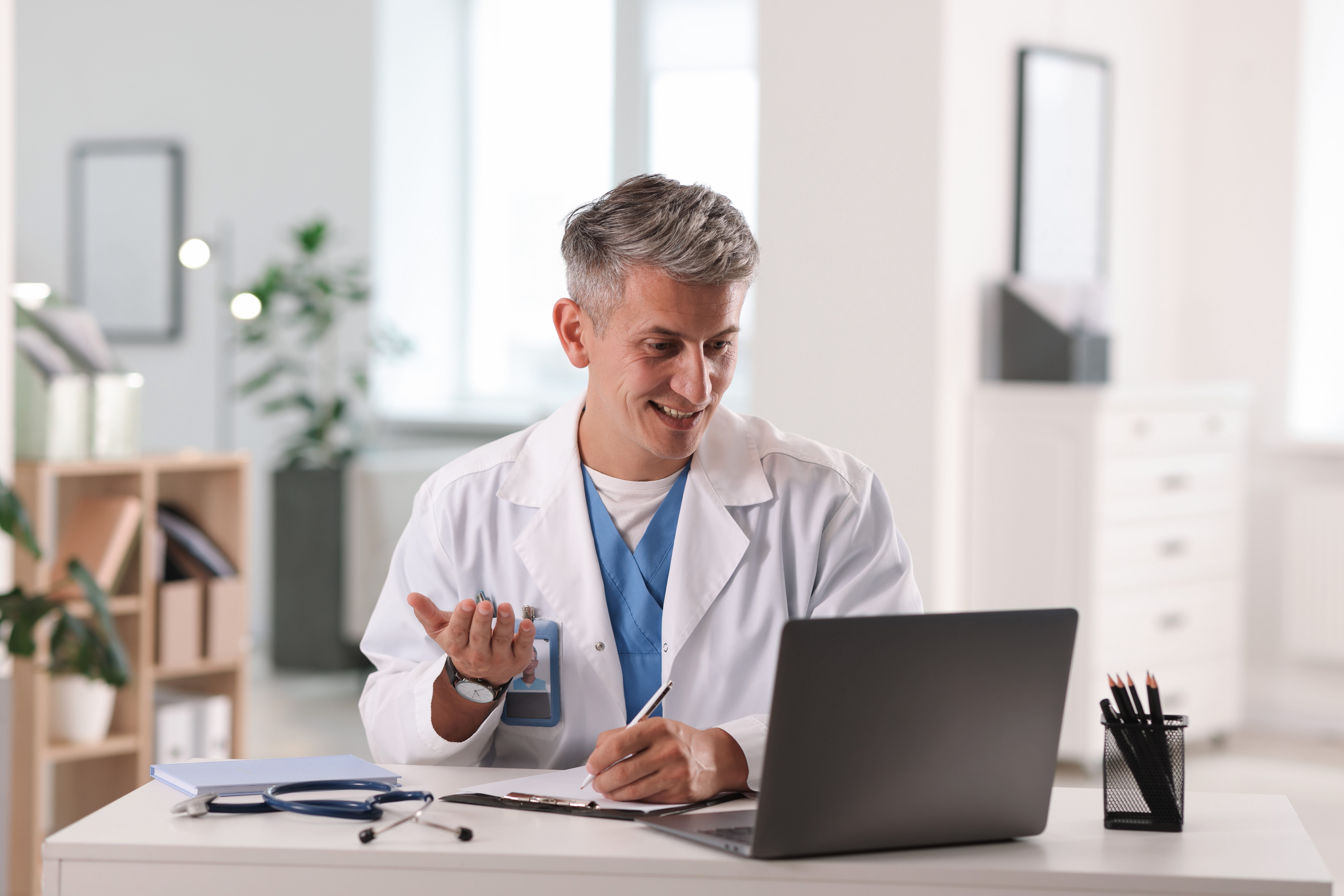 telemedicine.,doctor,having,video,call,with,patient,via,laptop,indoors