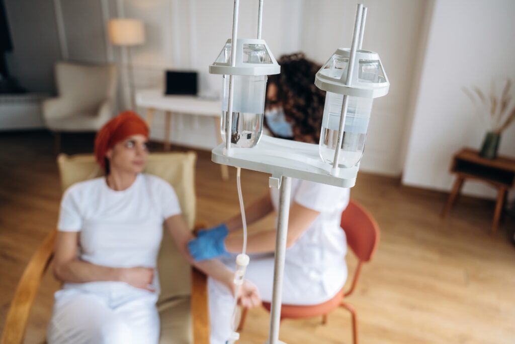 female,patient,undergoing,chemotherapy,sits,in,a,chair,while,a