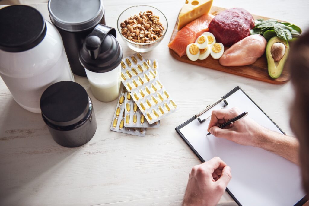 cropped,image,of,handsome,young,sportsman,making,notes,while,preparing