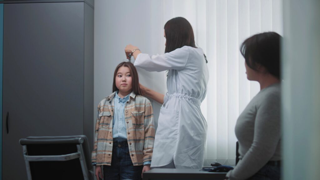 female,doctor,,endocrinologist,weighs,and,measures,height,of,asian,girl