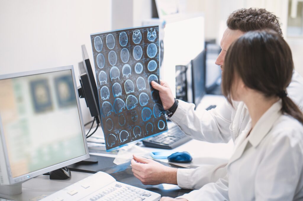 two,doctors,man,and,woman,doctor,examine,an,mri,image