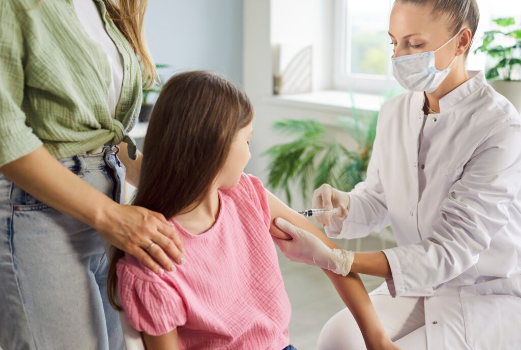 child,receives,vaccination,injection,from,doctor.,a,nurse,uses,a