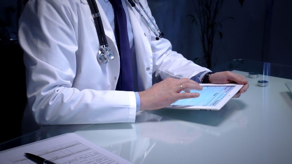 medical,doctor,analyzing,digital,health,records,on,a,tablet,computer,
