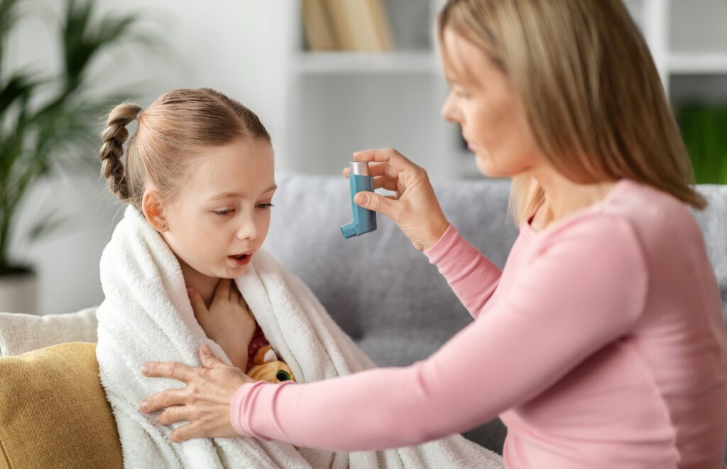preventing,attack.,caring,mother,giving,asthma,inhaler,to,sick,child
