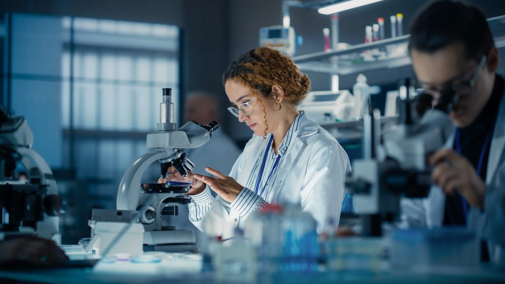 hisplanic,female,bioengineer,looking,at,dna,samples,under,a,microscope