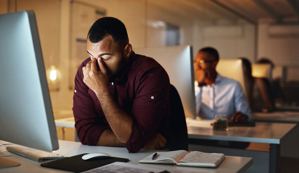 employee,,night,and,man,with,a,headache,,burnout,and,depression