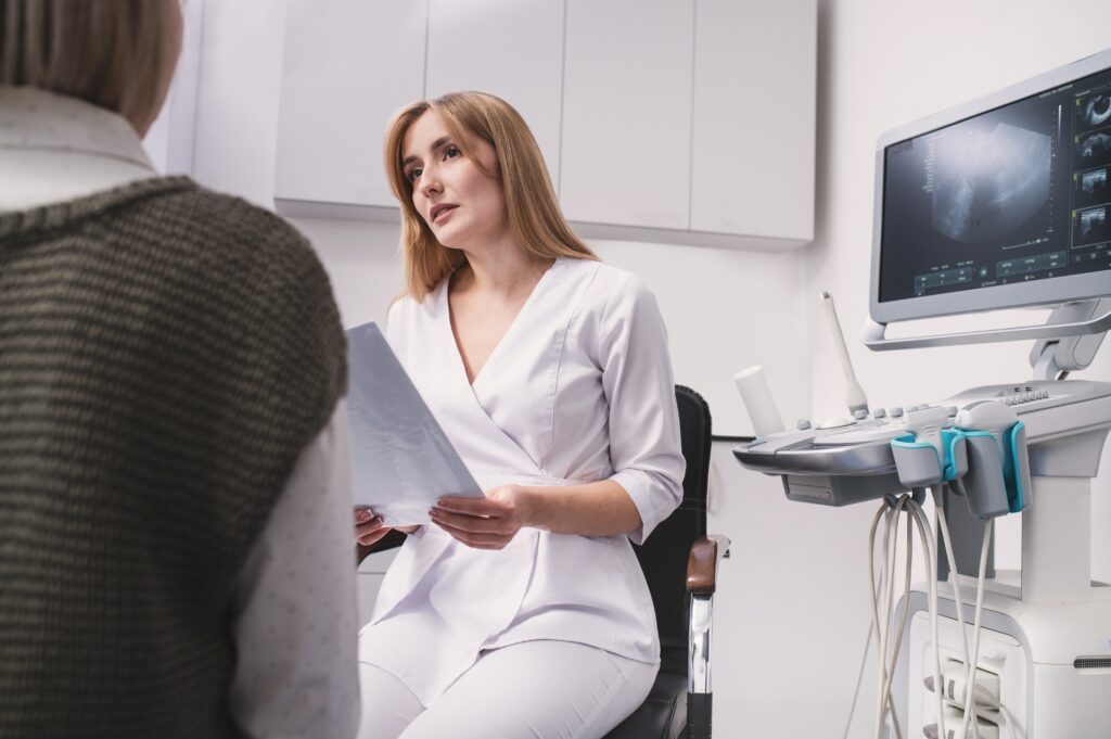 female,professional,doctor,studying,ultrasound,examination,results,reading,medical,records,