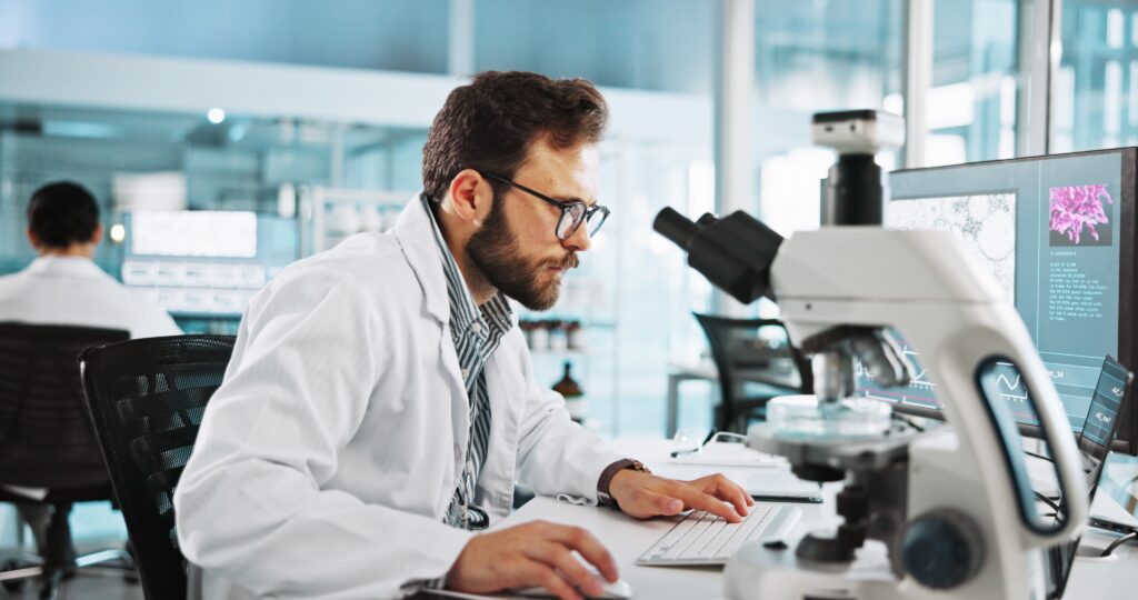 microscope,,computer,and,research,with,man,in,laboratory,for,tissue